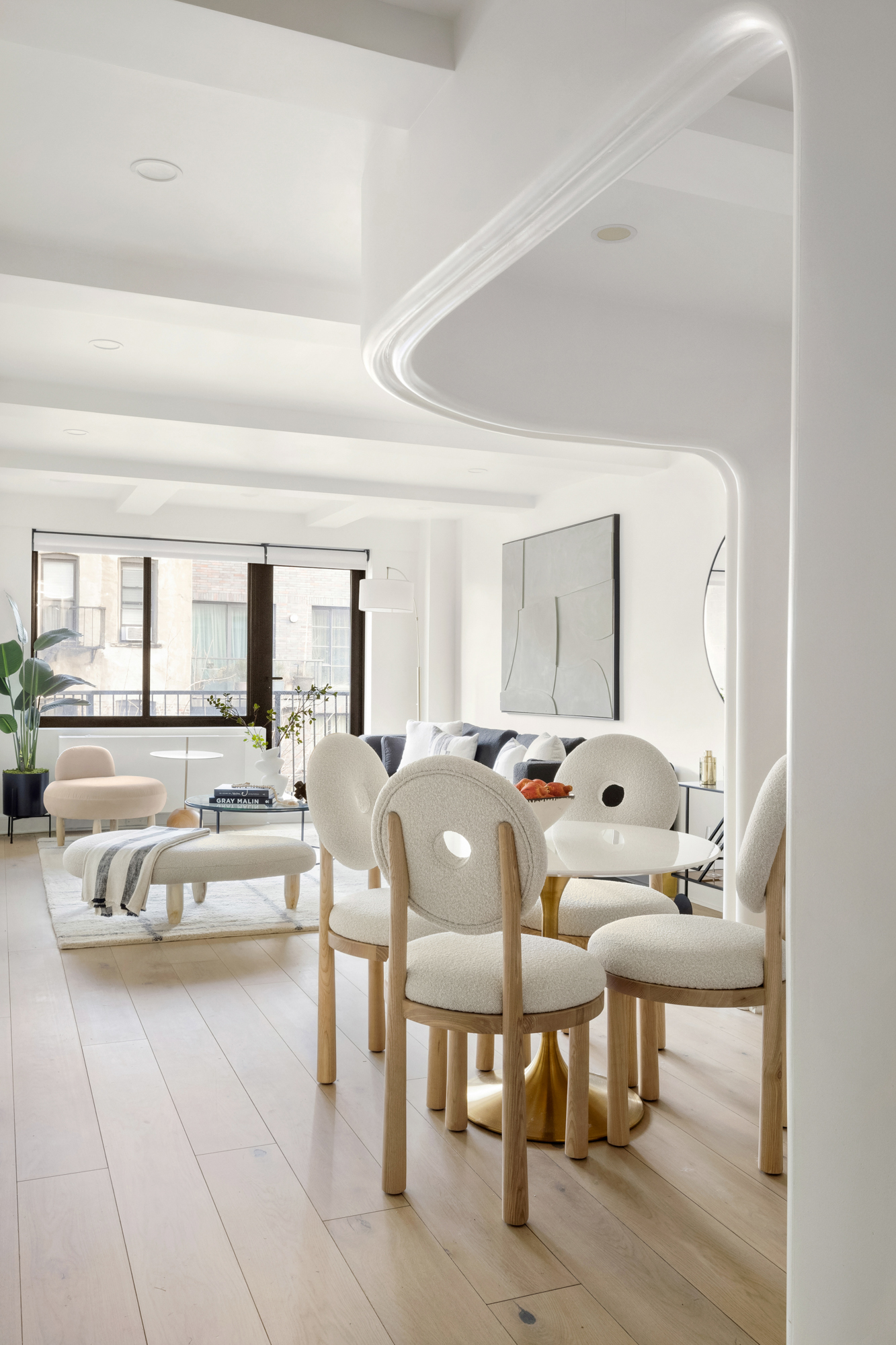 533 East 12th Street, Unit 6D Manhattan, NY 10009 - Photo 8 of 14 a living room with furniture and a large window