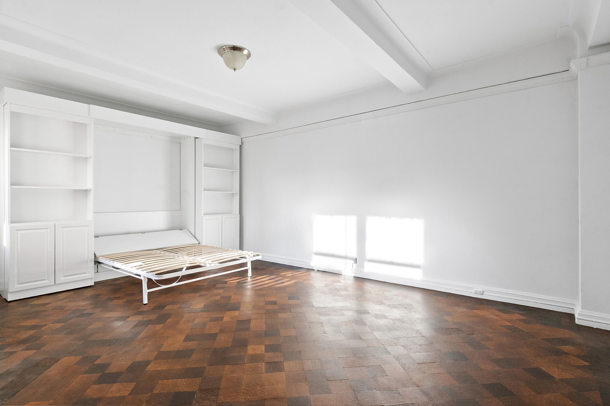 70 Remsen Street, Unit 9D Brooklyn, NY 11201 - Photo 5 of 10 an empty room with wooden floor and white walls