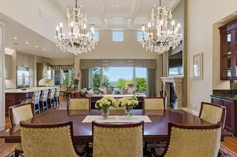 a living room with fireplace furniture and a chandelier