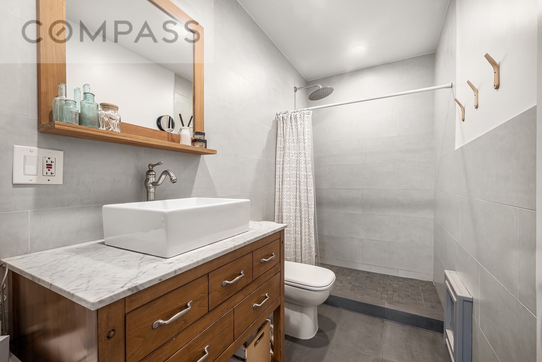 69 Sterling Street Brooklyn, NY 11225 - Photo 8 of 14 a bathroom with a sink a toilet and shower