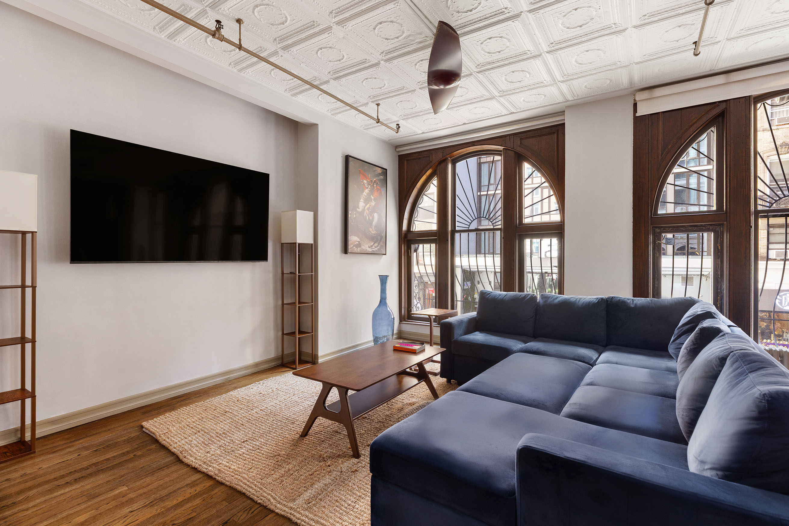 133-131 West 28th Street, Unit 2A Manhattan, NY 10001 - Photo 2 of 7 a living room with furniture tv and a window