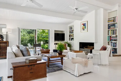 a living room with furniture and a book shelf