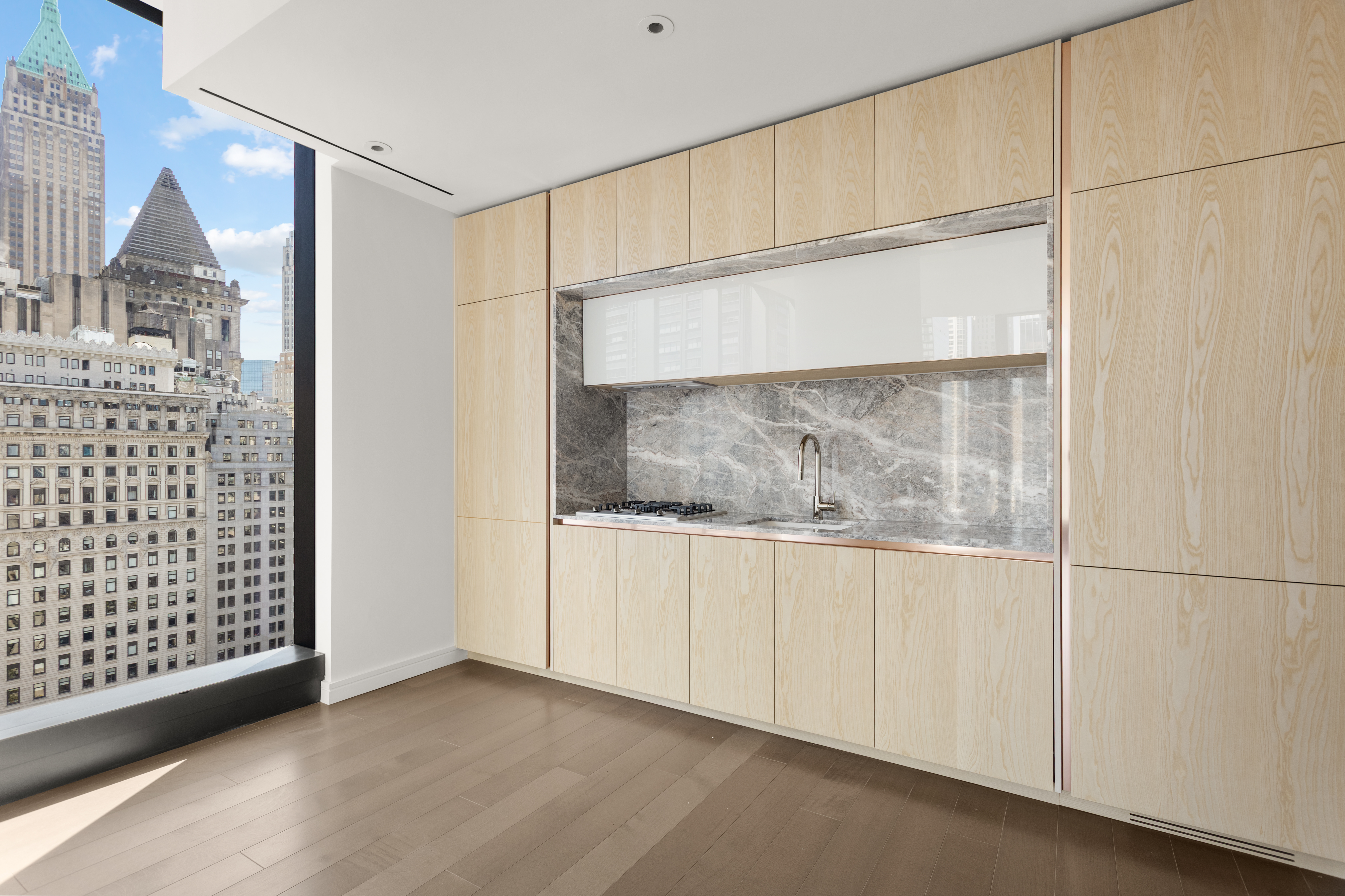 125 Greenwich Street, Unit 31A Manhattan, NY 10006 - Photo 5 of 23 a view of an empty room with wooden floor and a cabinet