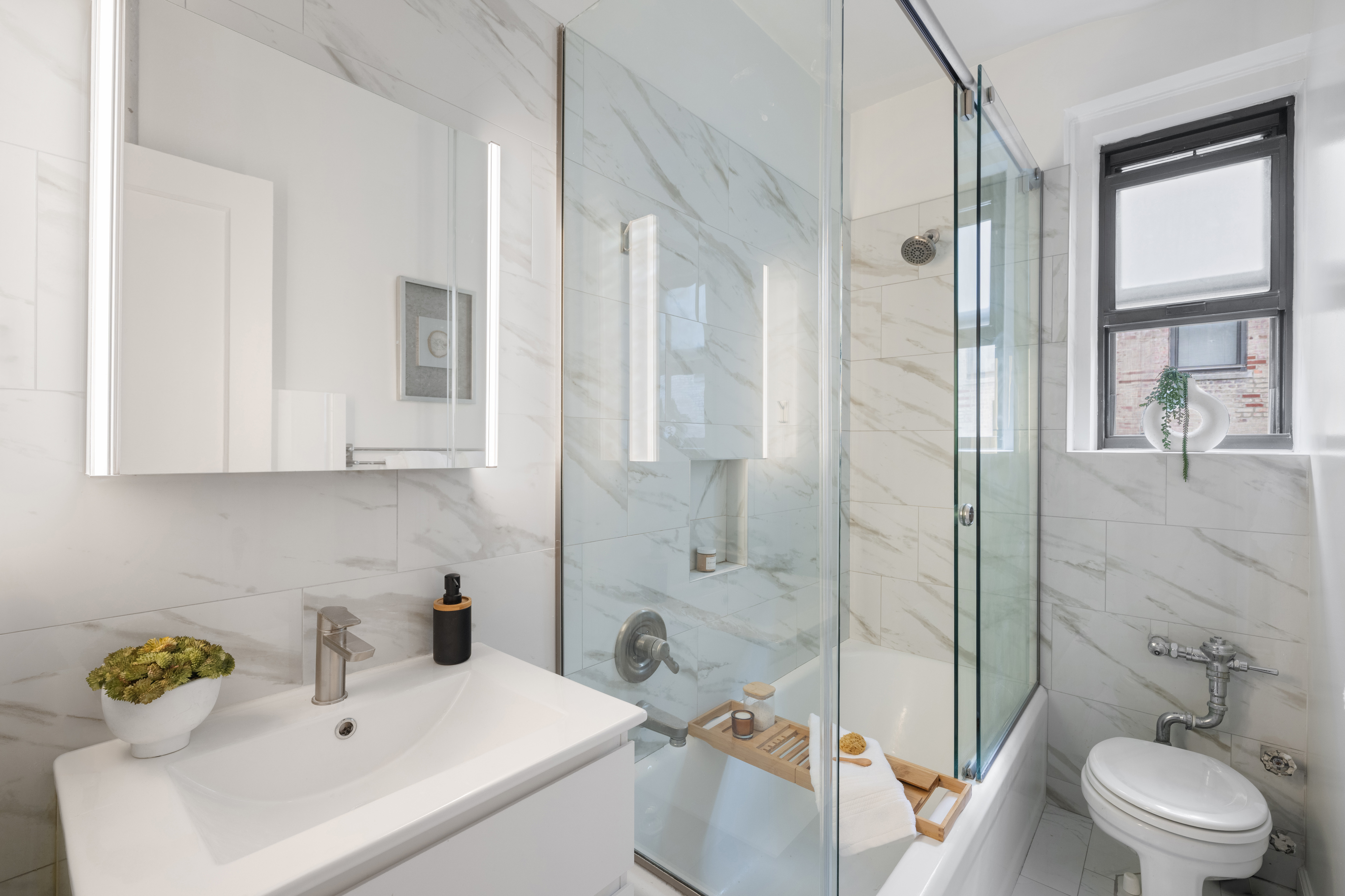 350 Cabrini Boulevard, Unit 7N Manhattan, NY 10040 - Photo 9 of 10 a bathroom with a sink toilet and shower