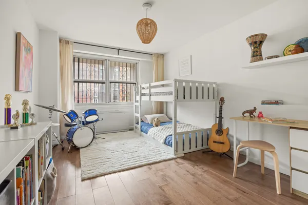 a bedroom with furniture and a window