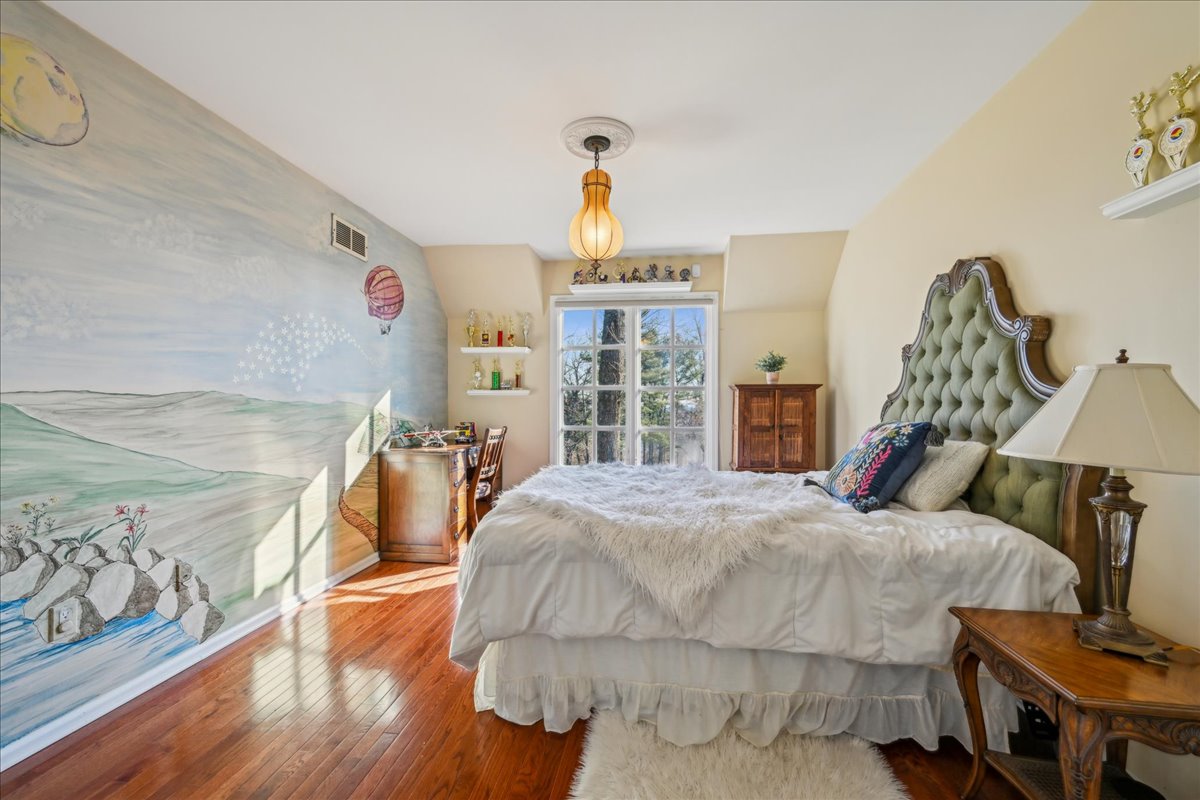 Johnston Drive Watchung, NJ 07069 - Photo 51 of 85 a bedroom with a bed and wooden floor