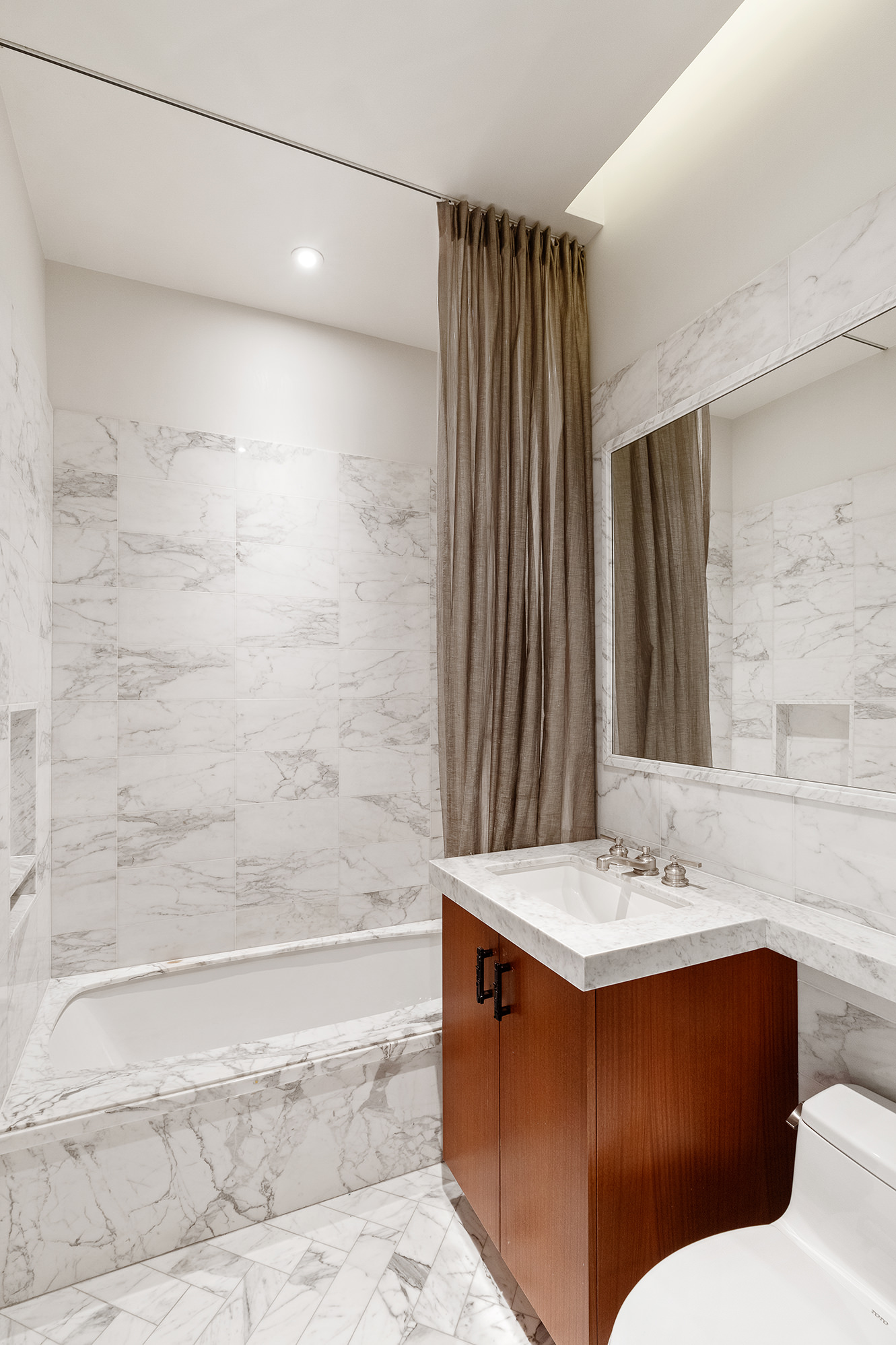 260 Park Avenue South, Unit 6B Manhattan, NY 10010 - Photo 11 of 13 a bathroom with a sink and a mirror