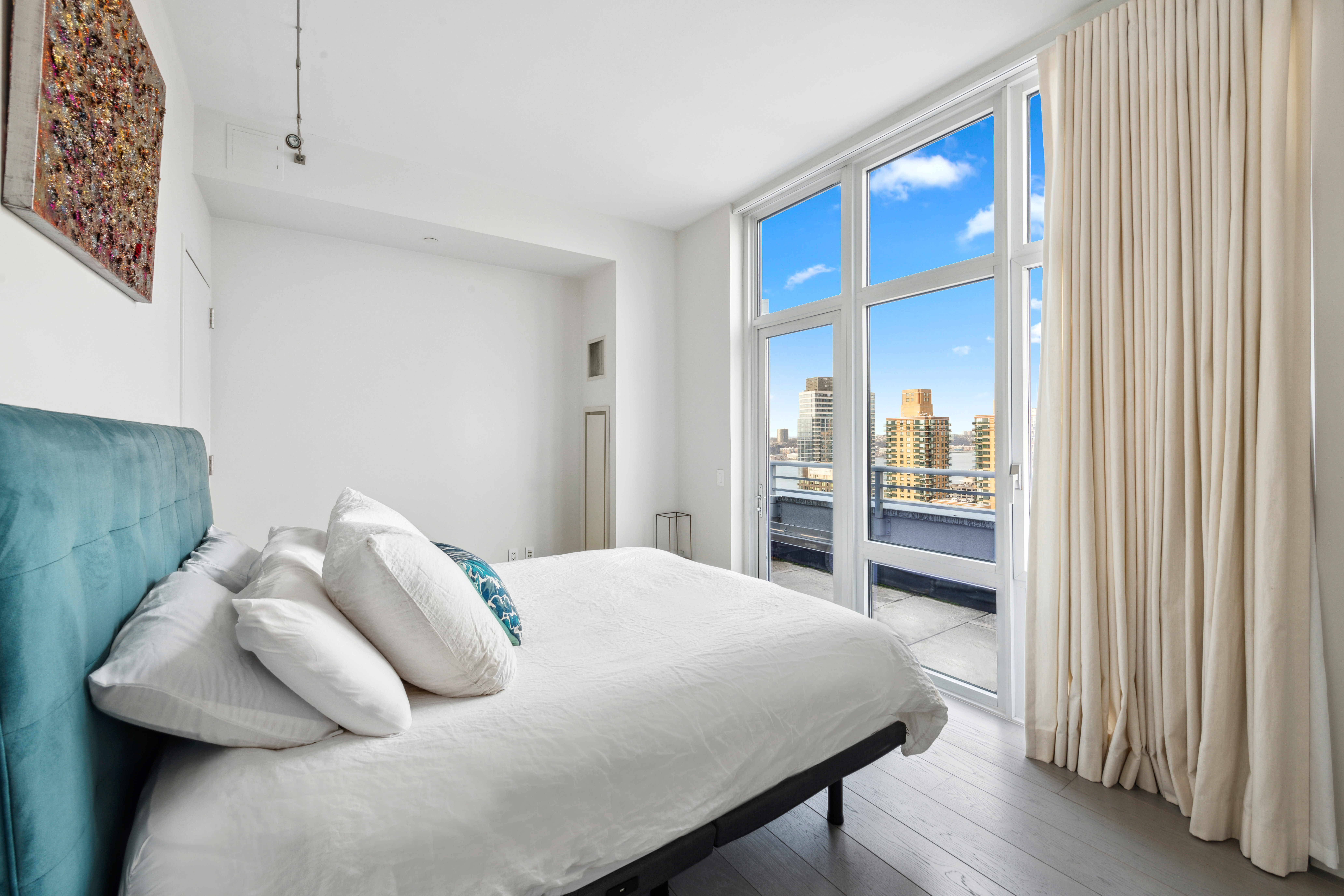 555 West 59th Street, Unit PHA Manhattan, NY 10019 - Photo 12 of 20 a bedroom with a bed and a cabinets