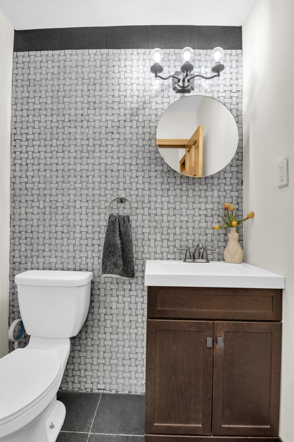 137 West 126th Street, Unit 1 Manhattan, NY 10027 - Photo 10 of 12 a bathroom with a sink a toilet and a mirror