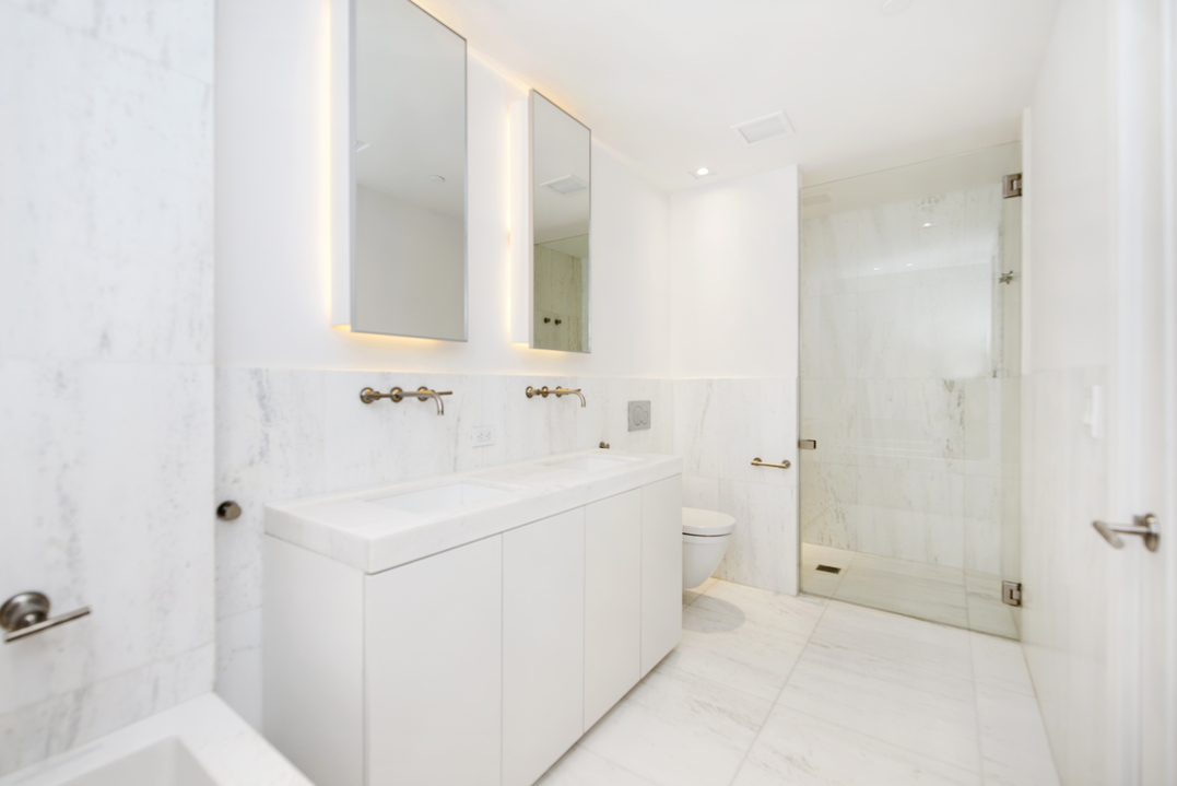 101 Wall Street, Unit 12C Manhattan, NY 10005 - Photo 8 of 18 a bathroom with a sink and a mirror