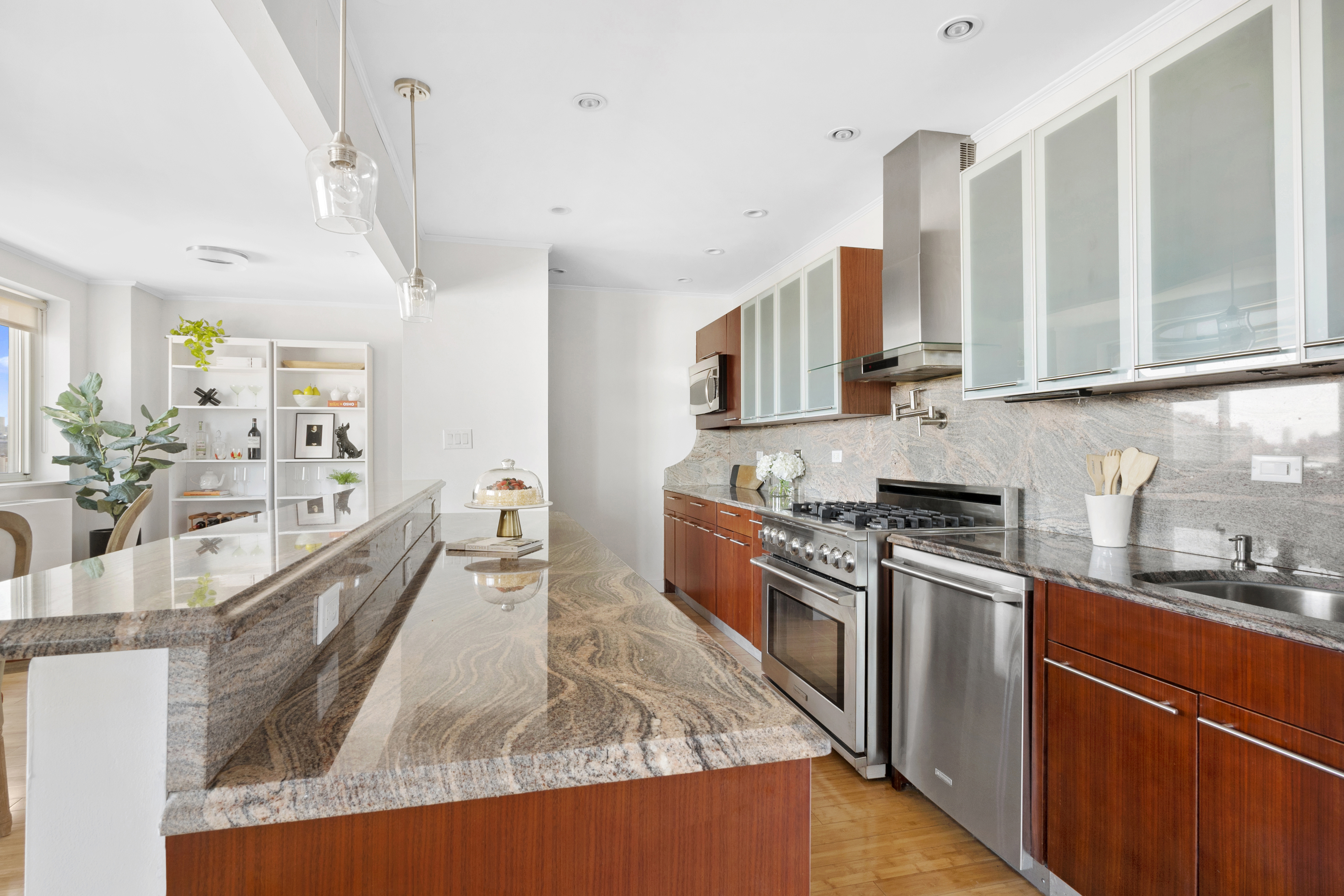301 West 115th Street, Unit PH4C Manhattan, NY 10026 - Photo 3 of 15 a kitchen with stainless steel appliances granite countertop a stove a sink and a refrigerator