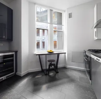 a view of a dining room with furniture and a window
