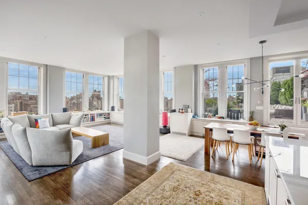 a living room with furniture and large windows