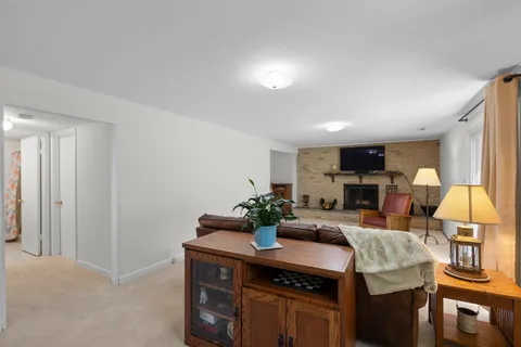 a kitchen room with granite countertop lots of furniture and wooden floor