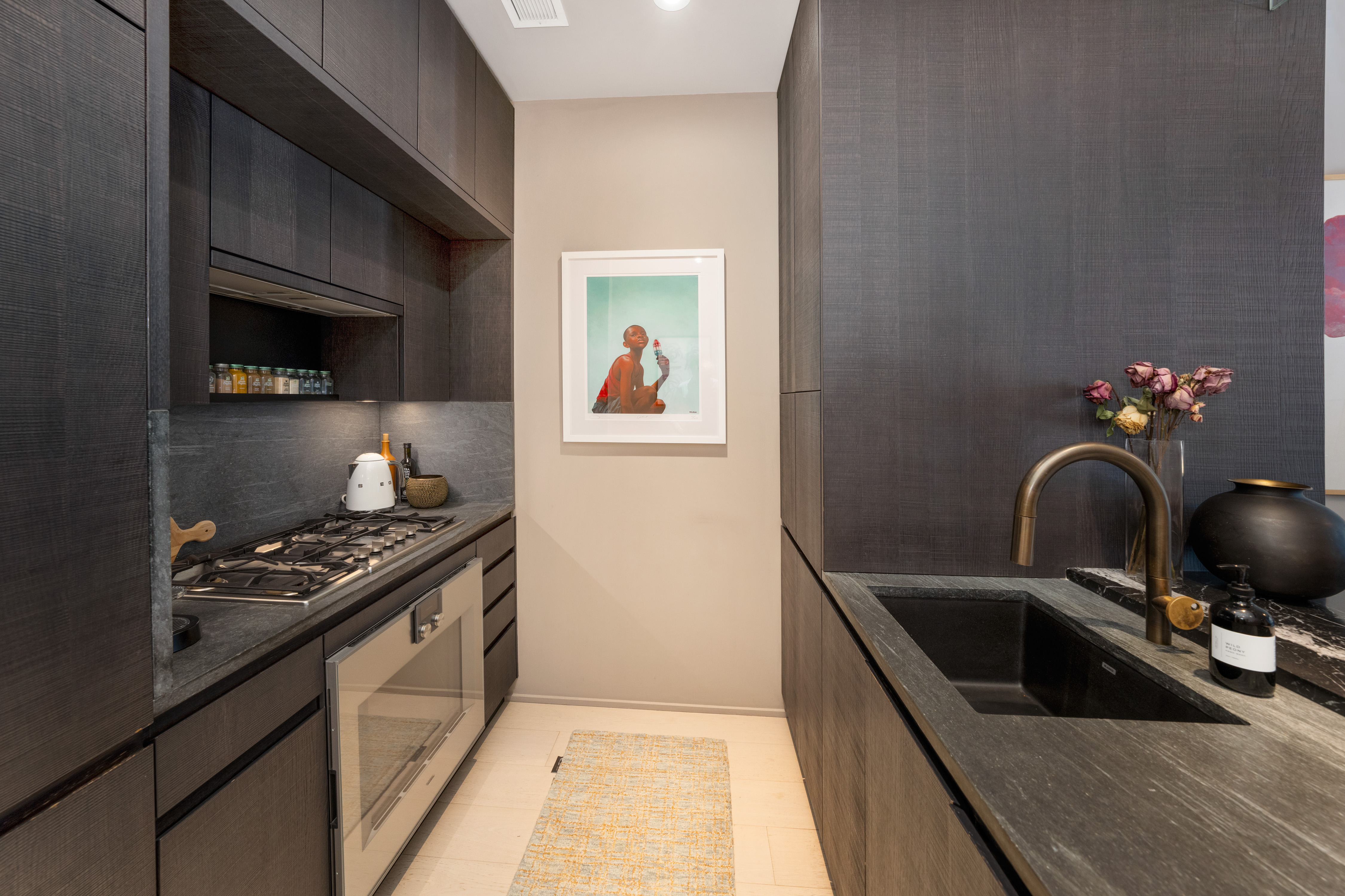 130 William Street, Unit 21A Manhattan, NY 10038 - Photo 5 of 13 a kitchen that has a sink and a stove