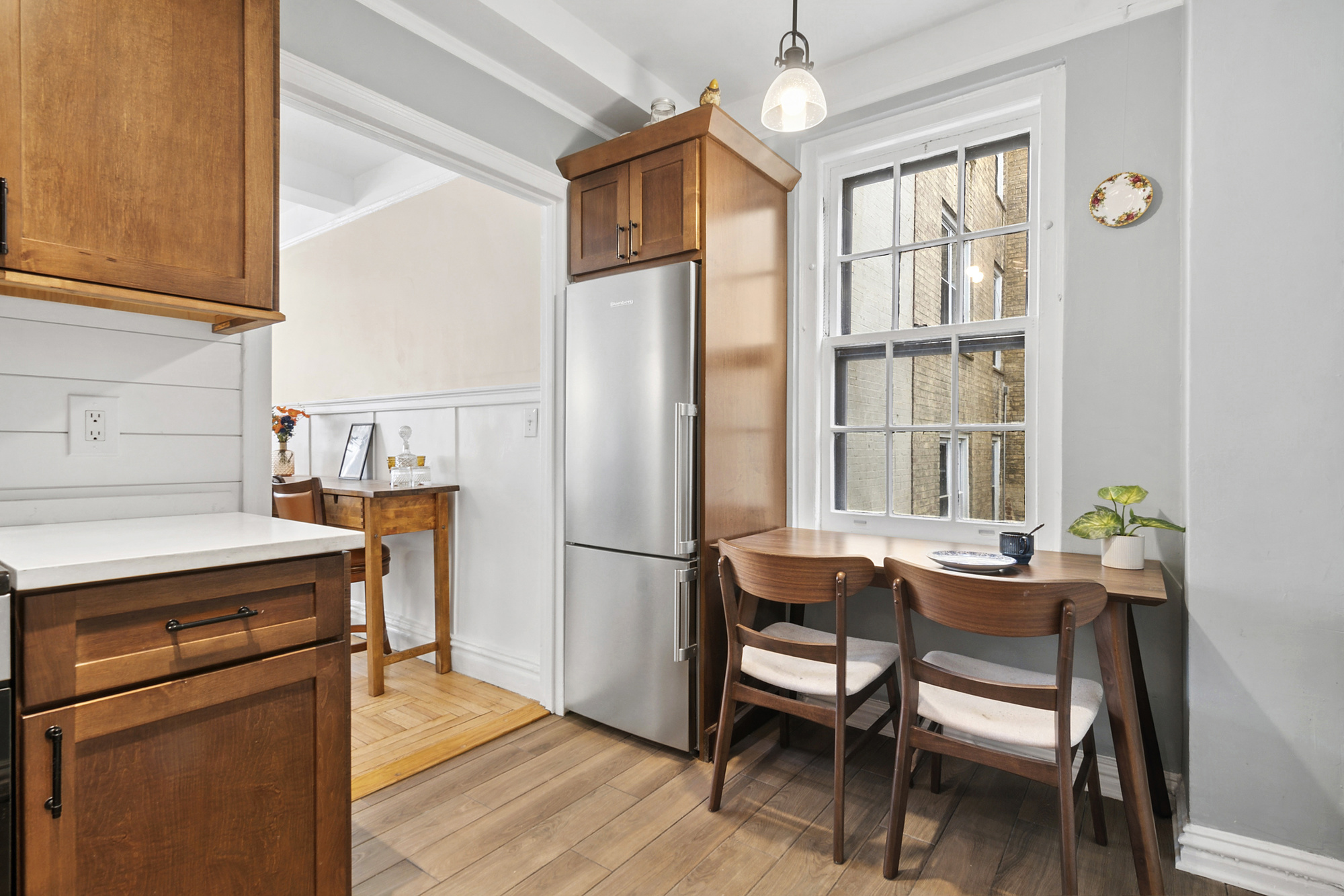 24 Monroe Place, Unit 1C Brooklyn, NY 11201 - Photo 3 of 10 a dining room with a table chairs and a kitchen view