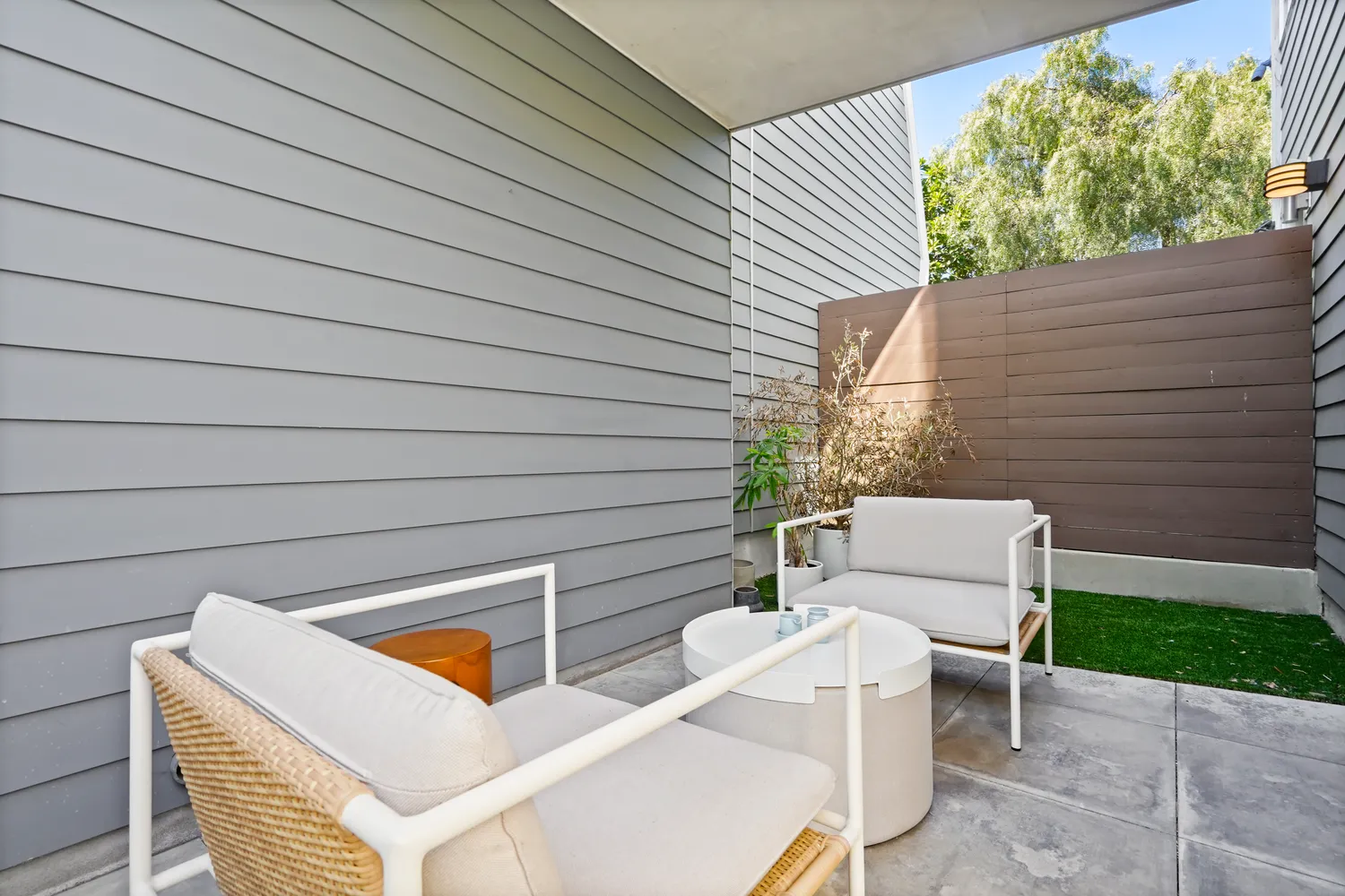 a view of a patio with table and chairs with wooden floor and fence
