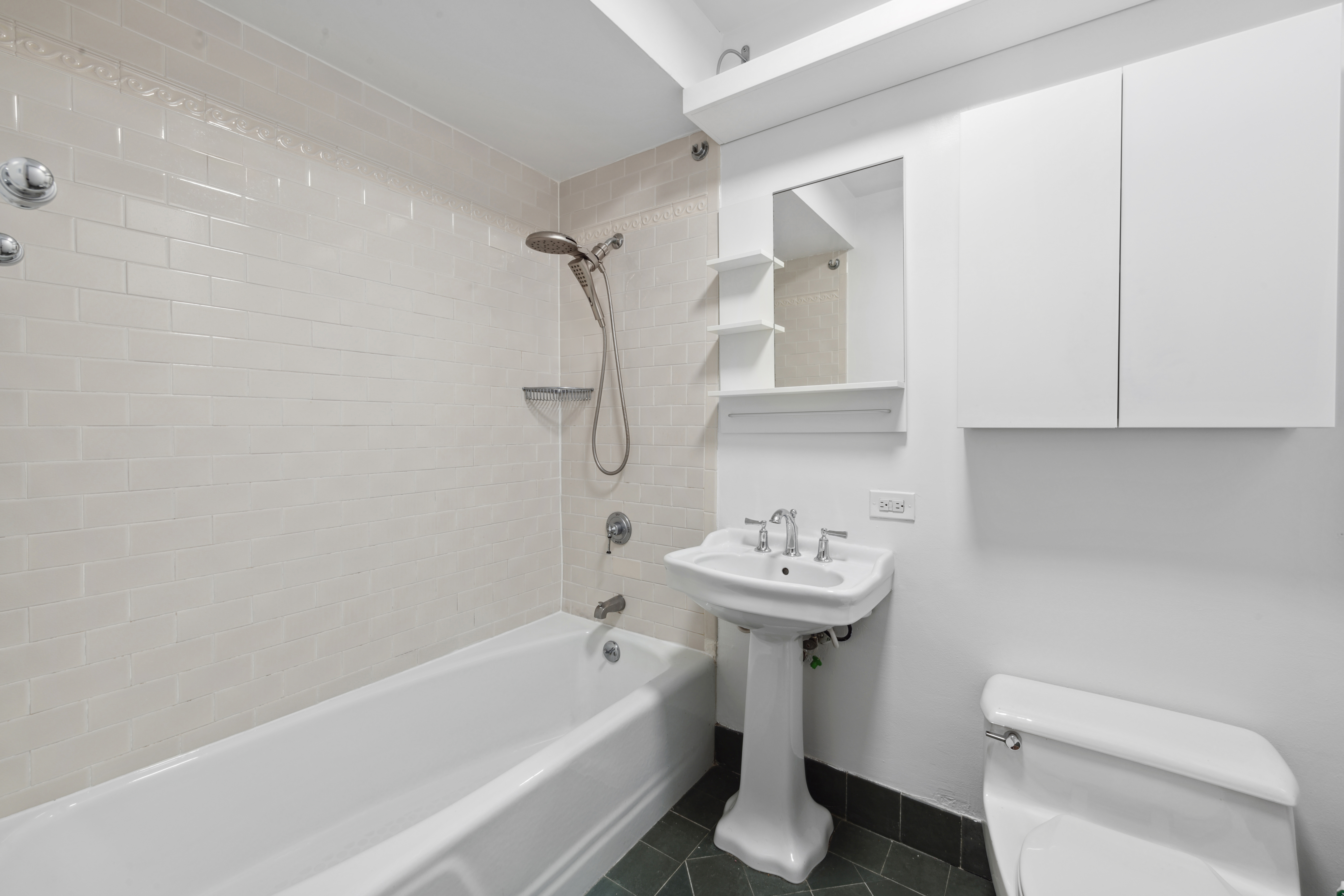 201 West 72nd Street, Unit 3I Manhattan, NY 10023 - Photo 7 of 13 a bathroom with a sink a toilet and bathtub