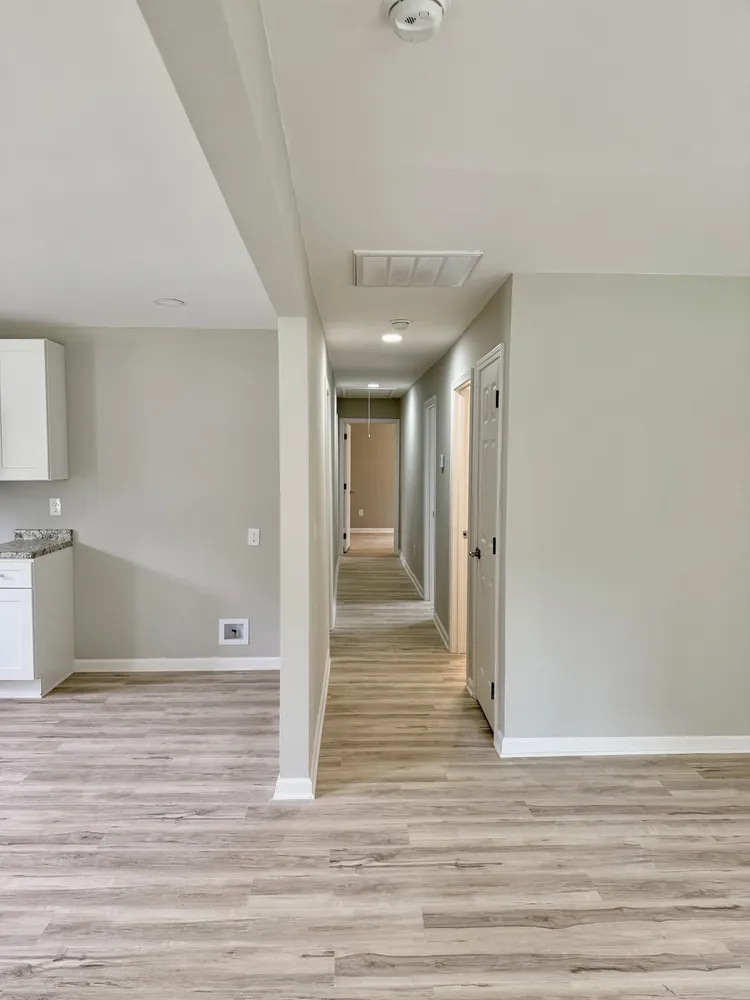 a view of a hallway with wooden floor