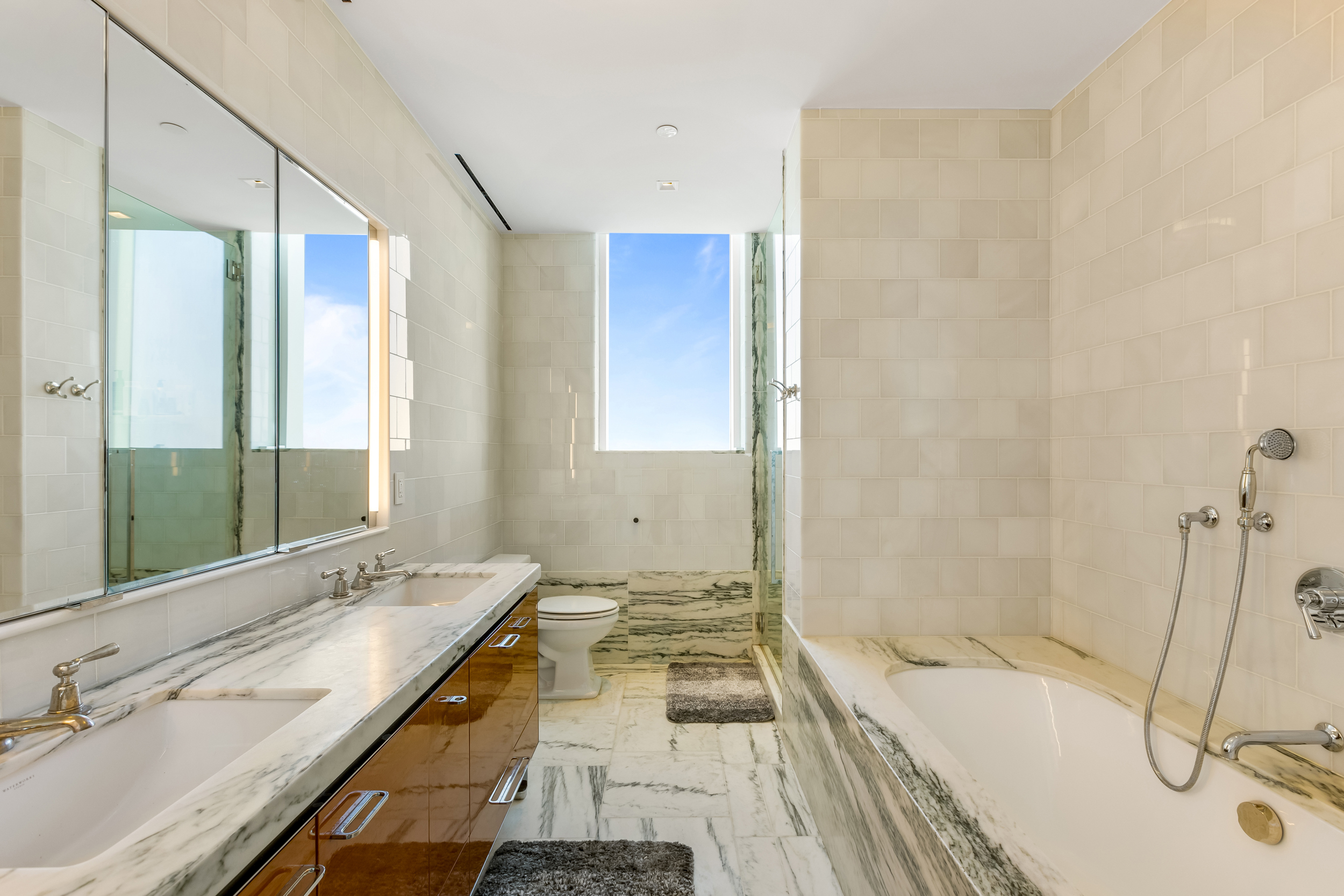 45 East 22nd Street, Unit 42B Manhattan, NY 10010 - Photo 8 of 23 a bathroom with a tub sink and mirror