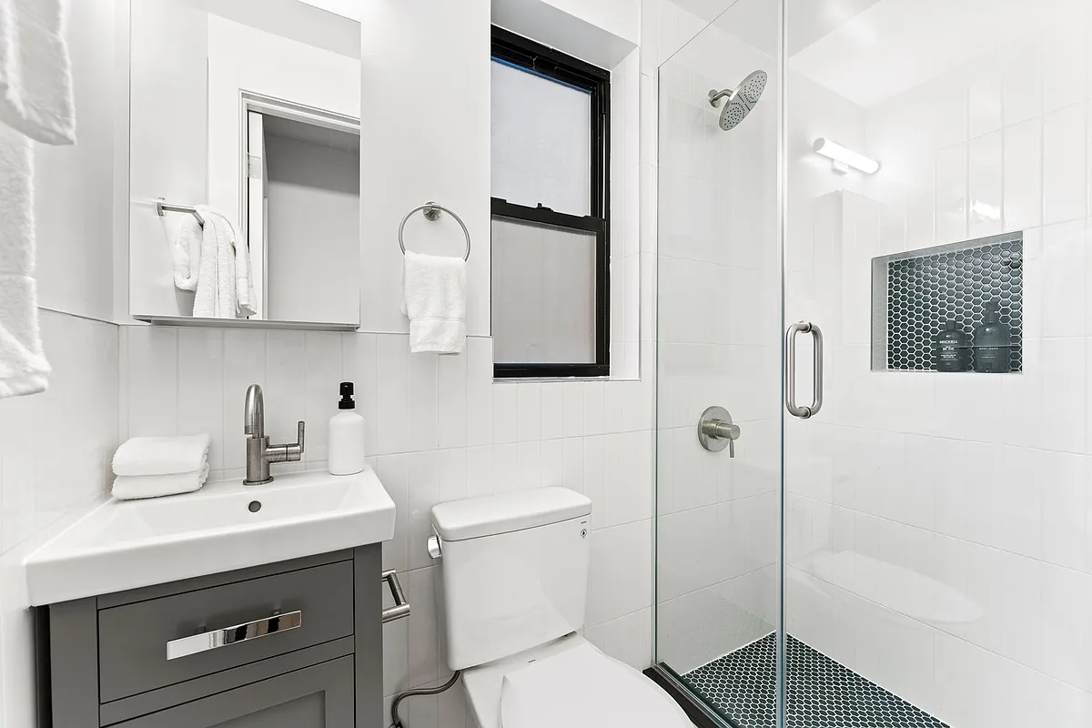 168 Sumpter Street, Unit 2 Brooklyn, NY 11233 - Photo 8 of 10 a bathroom with a sink a toilet and shower