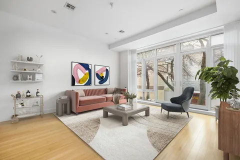 a living room with furniture or couch and a potted plant