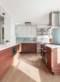 a kitchen with stainless steel appliances kitchen island granite countertop a stove a sink and a refrigerator