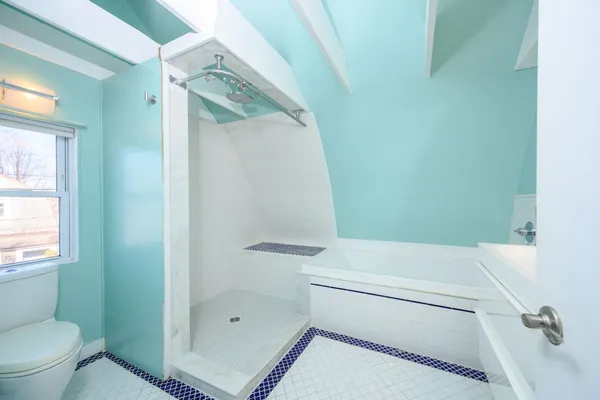 a en suite bathroom with a bathtub sink and mirror