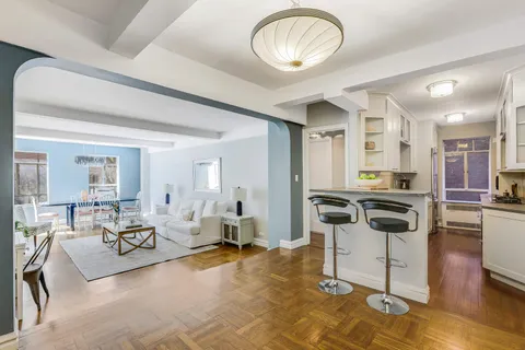 a kitchen with a stove a refrigerator and a stove top oven