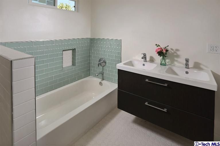 a bathroom with a bathtub and a sink