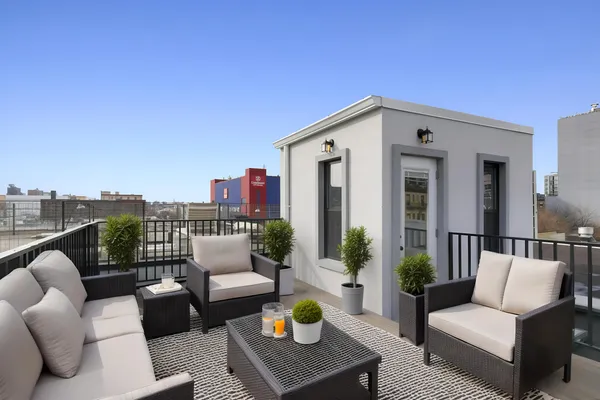 a view of a patio with couches chairs and a potted plant