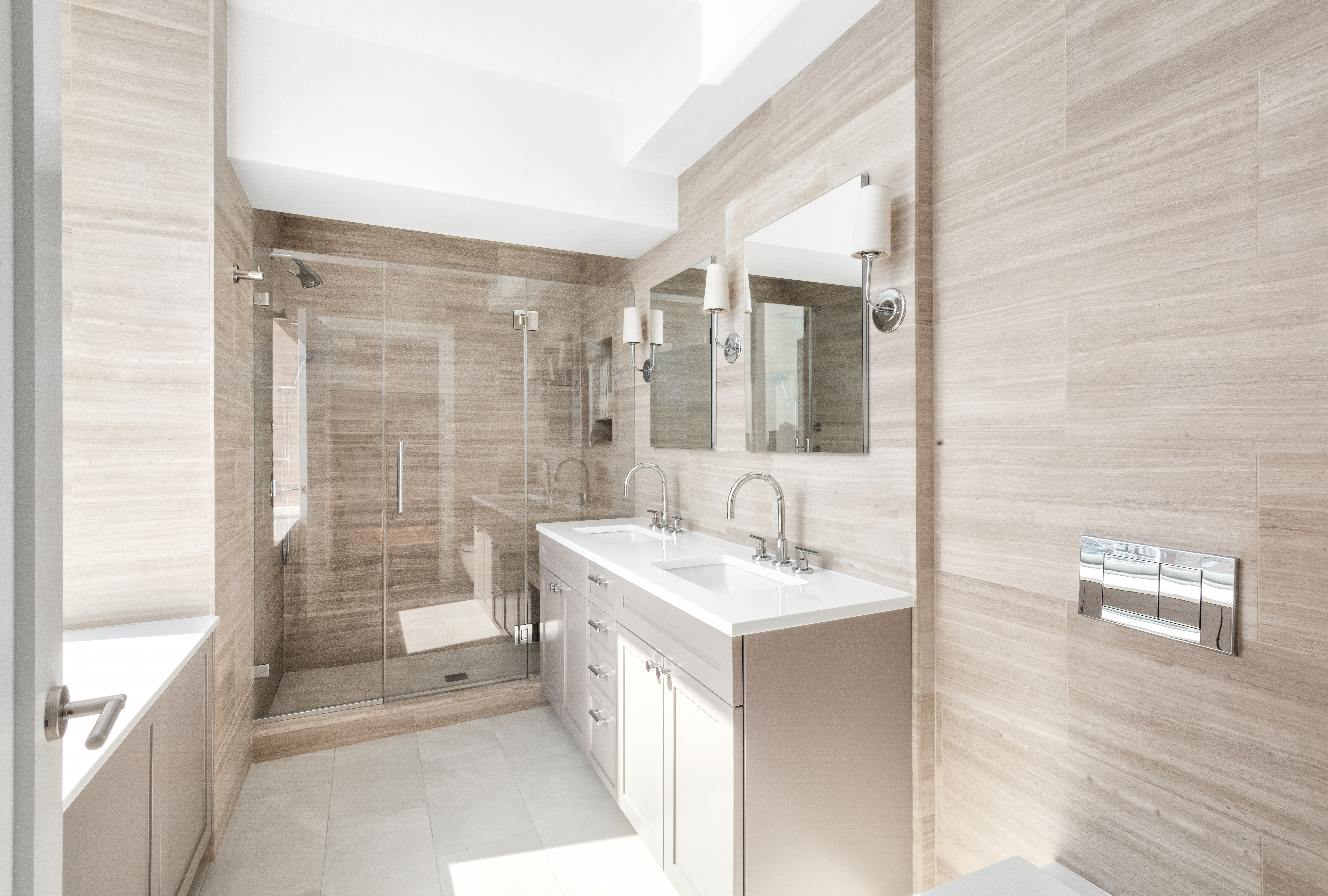 360 East 88th Street, Unit 20D Manhattan, NY 10128 - Photo 7 of 15 a spacious bathroom with a shower a sink and a mirror