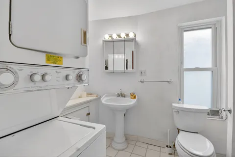a bathroom with a sink mirror and toilet