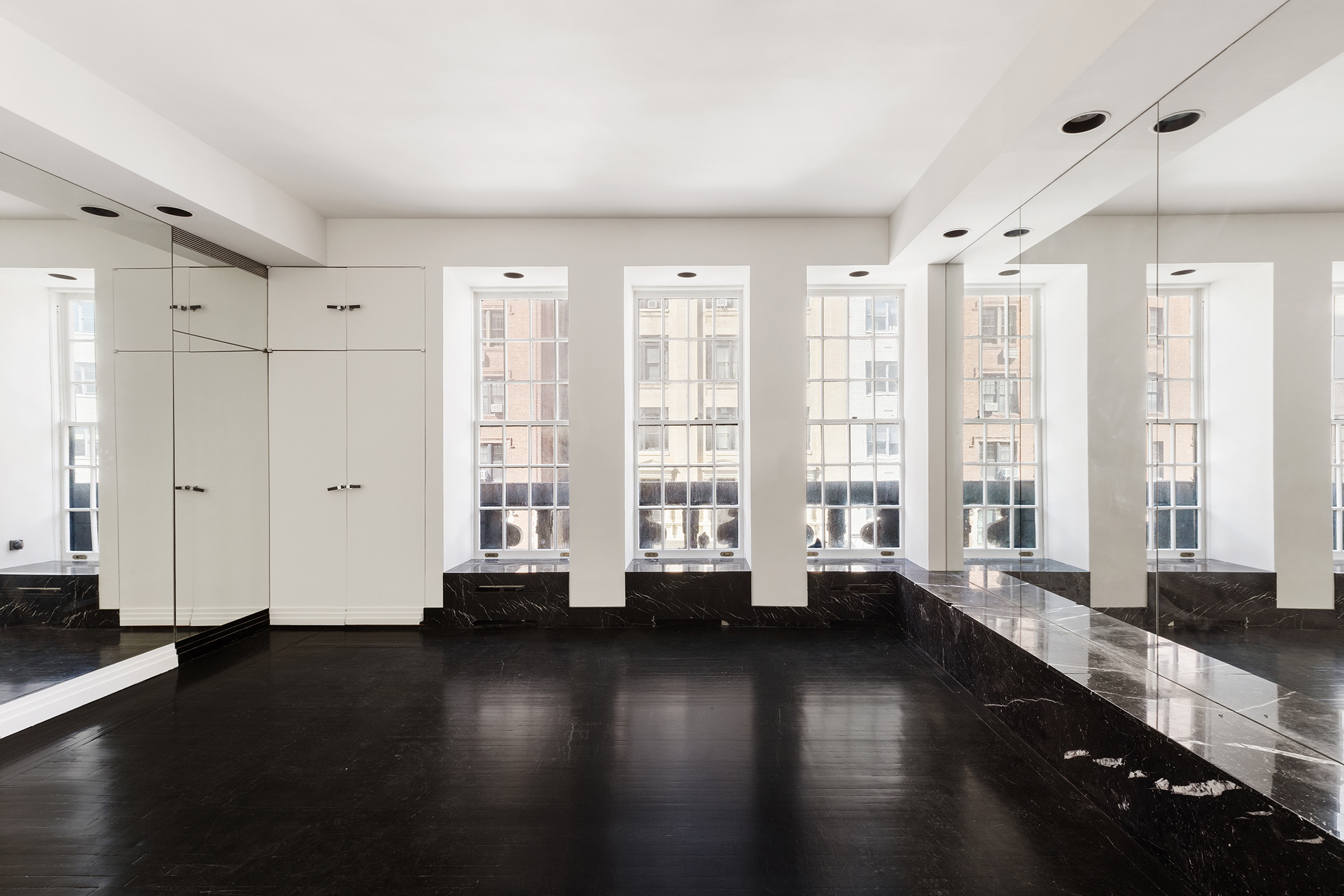 45 East 66th Street, Unit 4NW Manhattan, NY 10065 - Photo 11 of 29 a large room with wooden floor and windows