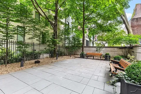 a view of a backyard with sitting area