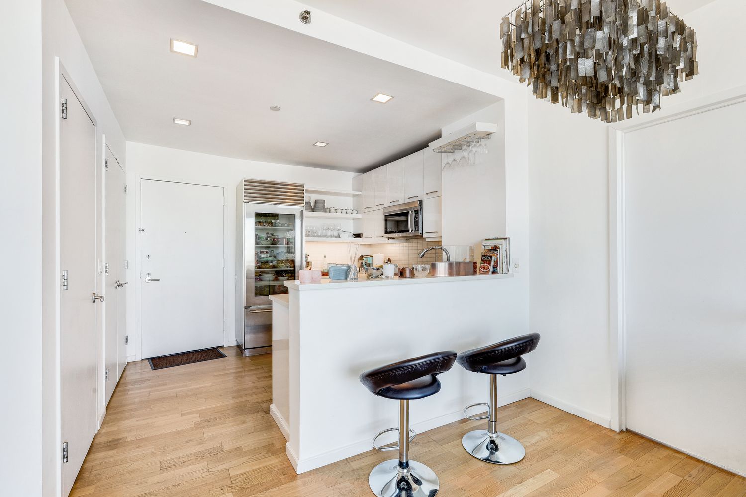 a room with table chairs and wooden floor