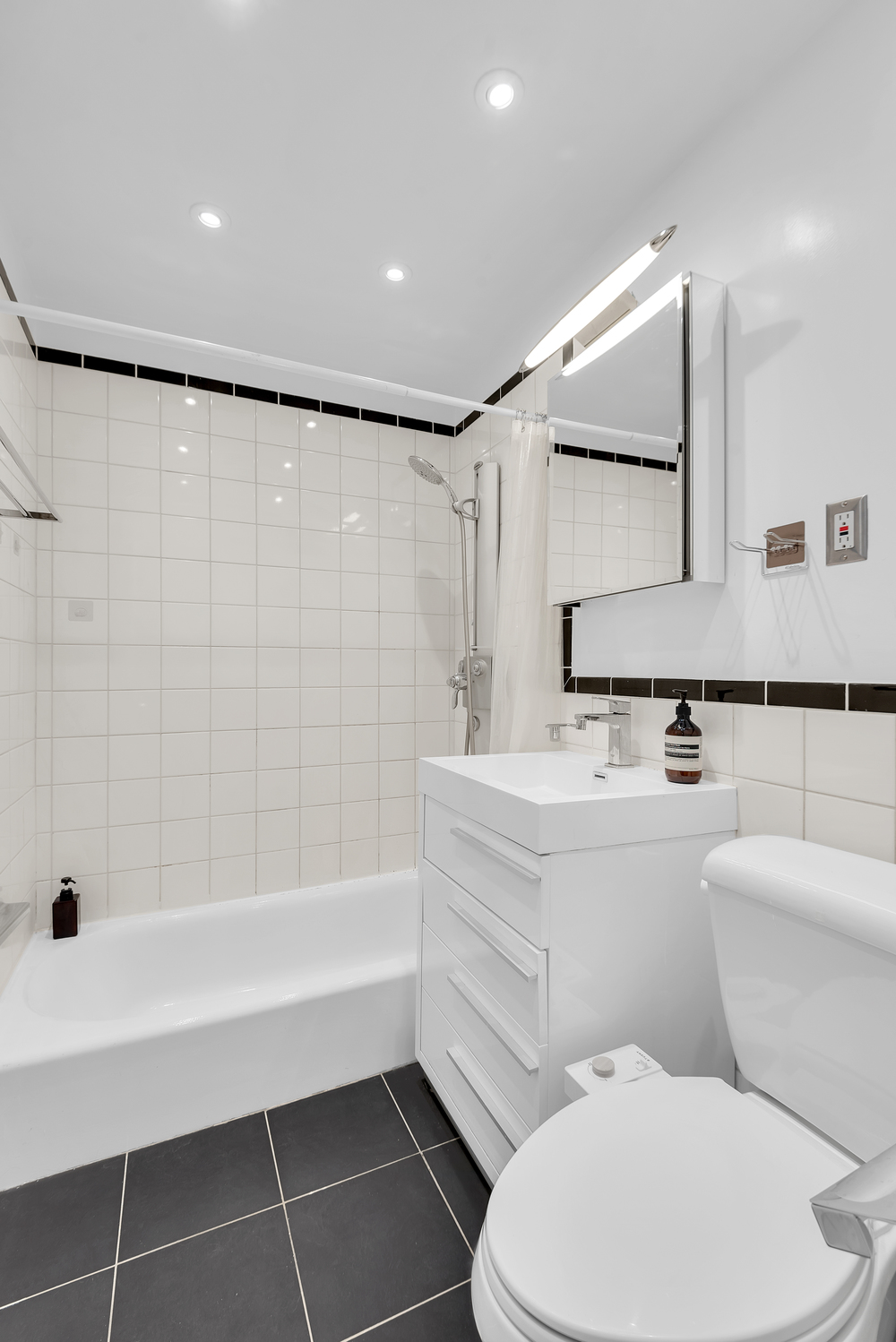 244 East 60th Street, Unit 3B Manhattan, NY 10022 - Photo 5 of 6 a bathroom with a toilet and a shower