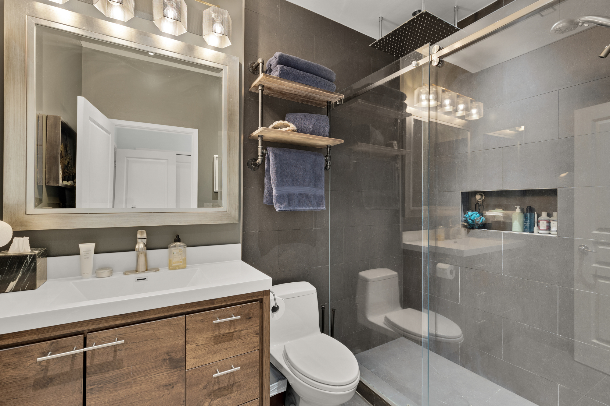 1407 15th Street Northwest, Unit 2 Washington, DC 20005 - Photo 16 of 24 a bathroom with a sink a toilet a mirror and shower