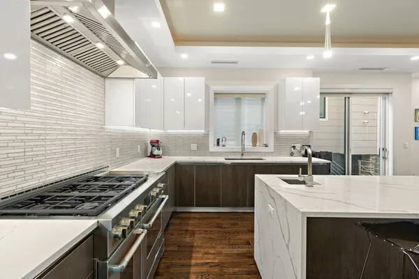 a kitchen with stainless steel appliances a sink stove and cabinets