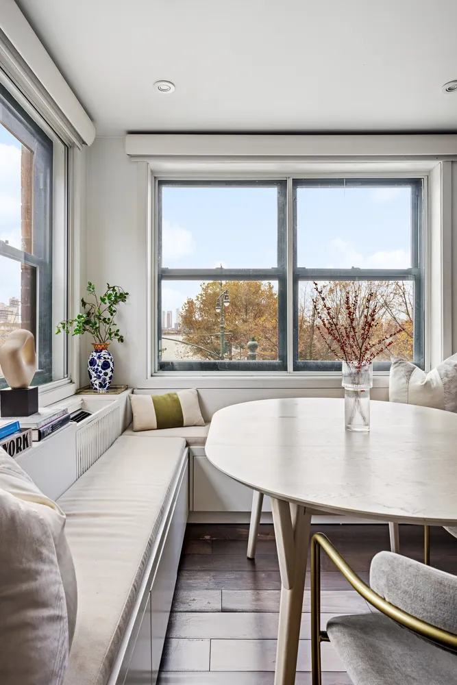 a living room with a table and a large window
