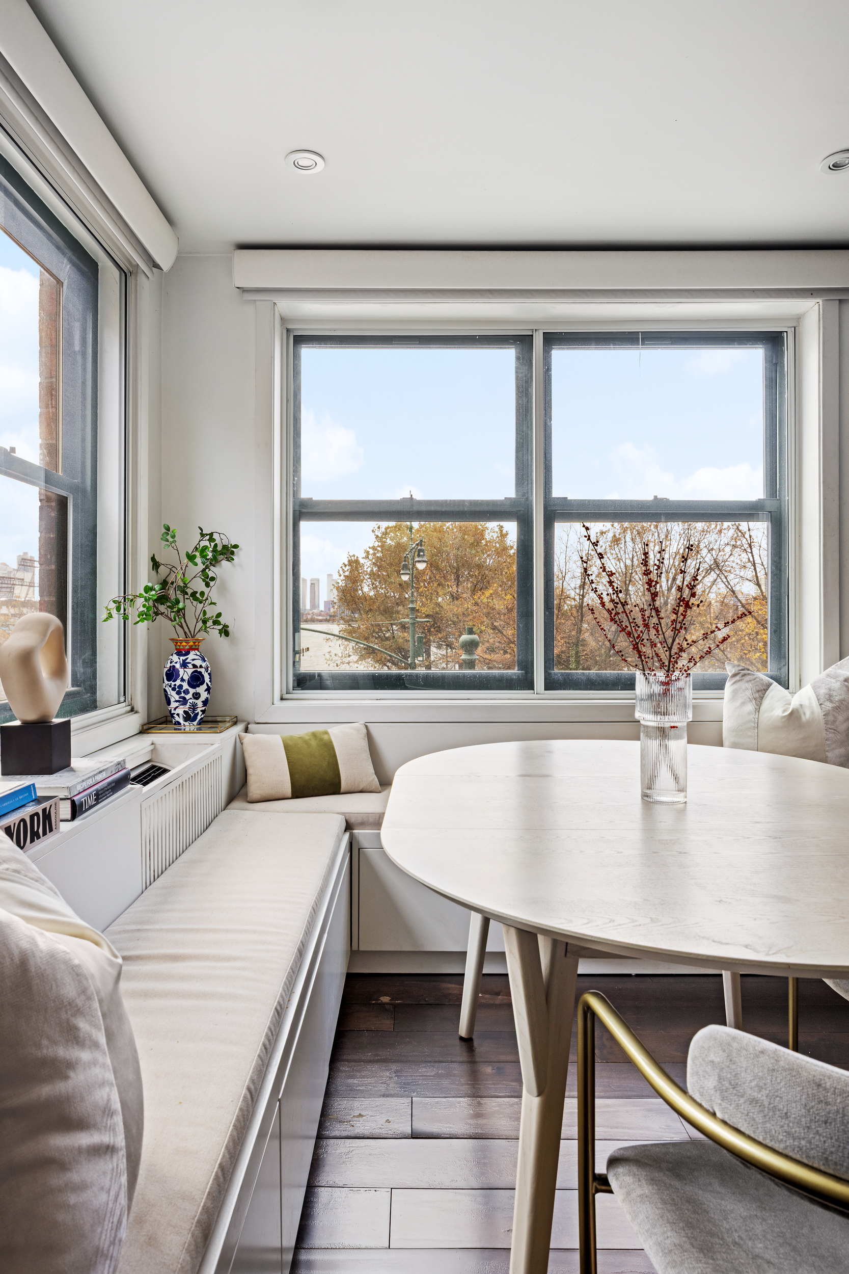 121 Morton Street, Unit 2A Manhattan, NY 10014 - Photo 3 of 9 a living room with a table and a large window