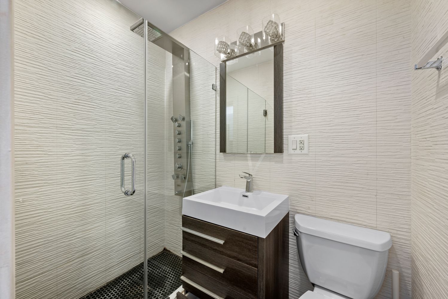 142 Sullivan Street, Unit 14 Manhattan, NY 10012 - Photo 6 of 10 a bathroom with a toilet sink and mirror