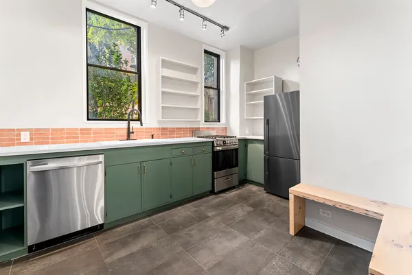a kitchen with a sink cabinets and stainless steel appliances