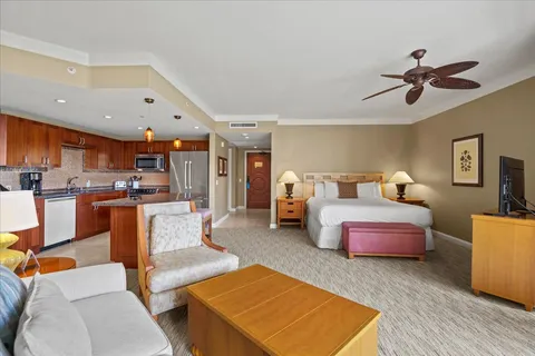 a bed room with furniture and a flat screen tv