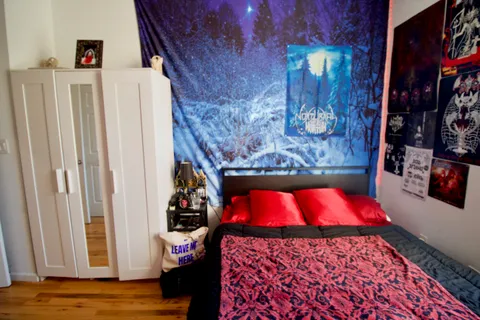 a bedroom with a bed and a window