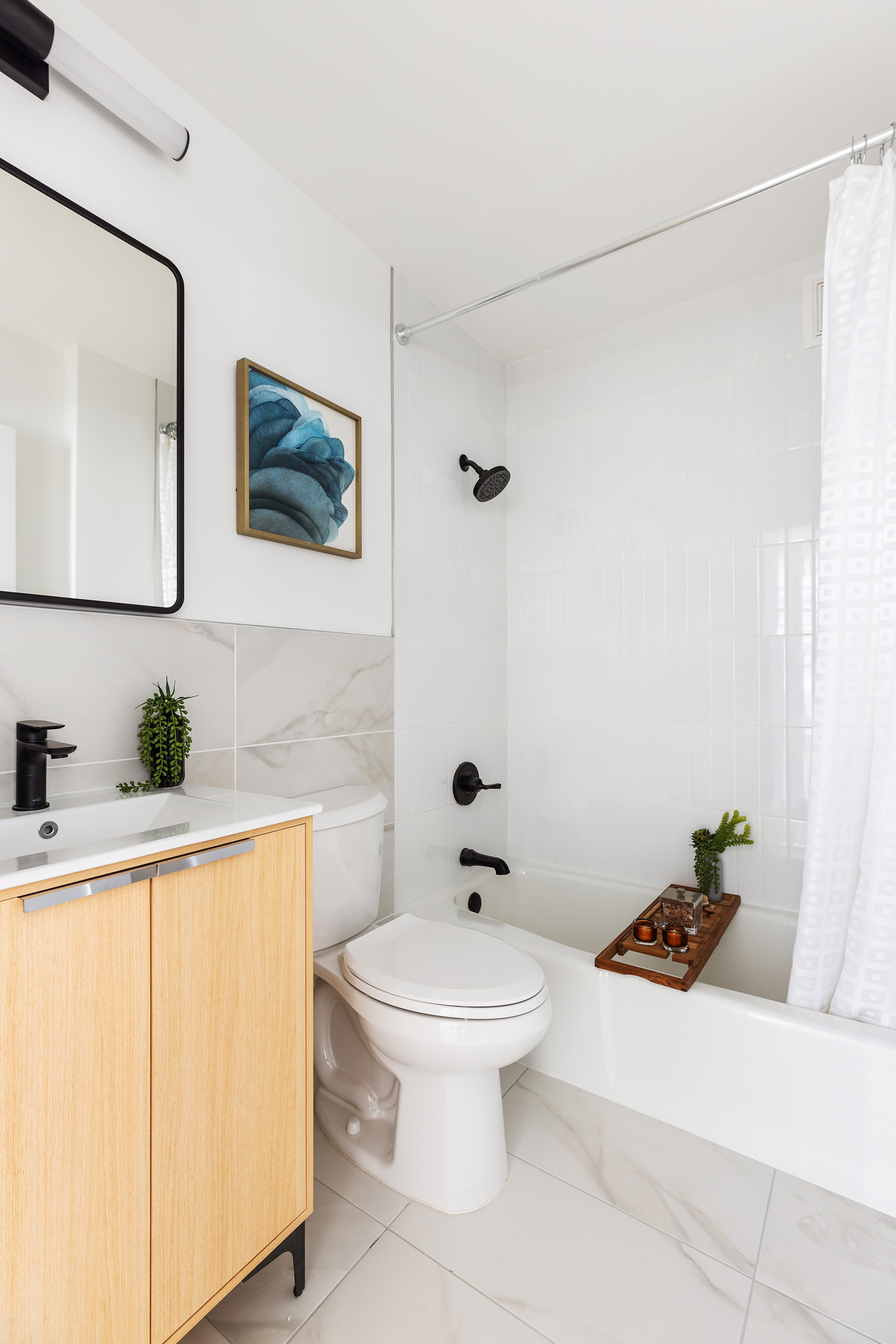 200 East 90th Street, Unit 12F Manhattan, NY 10128 - Photo 7 of 13 a bathroom with a sink a toilet and mirror