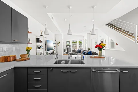 a view of a kitchen with sink and cabinets