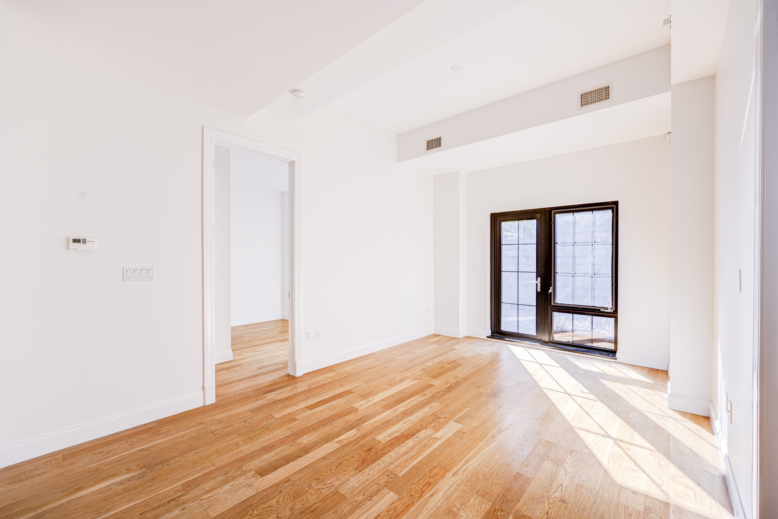 42 Maspeth Avenue, Unit 1D Brooklyn, NY 11211 - Photo 11 of 28 a view of a livingroom with wooden floor and a window