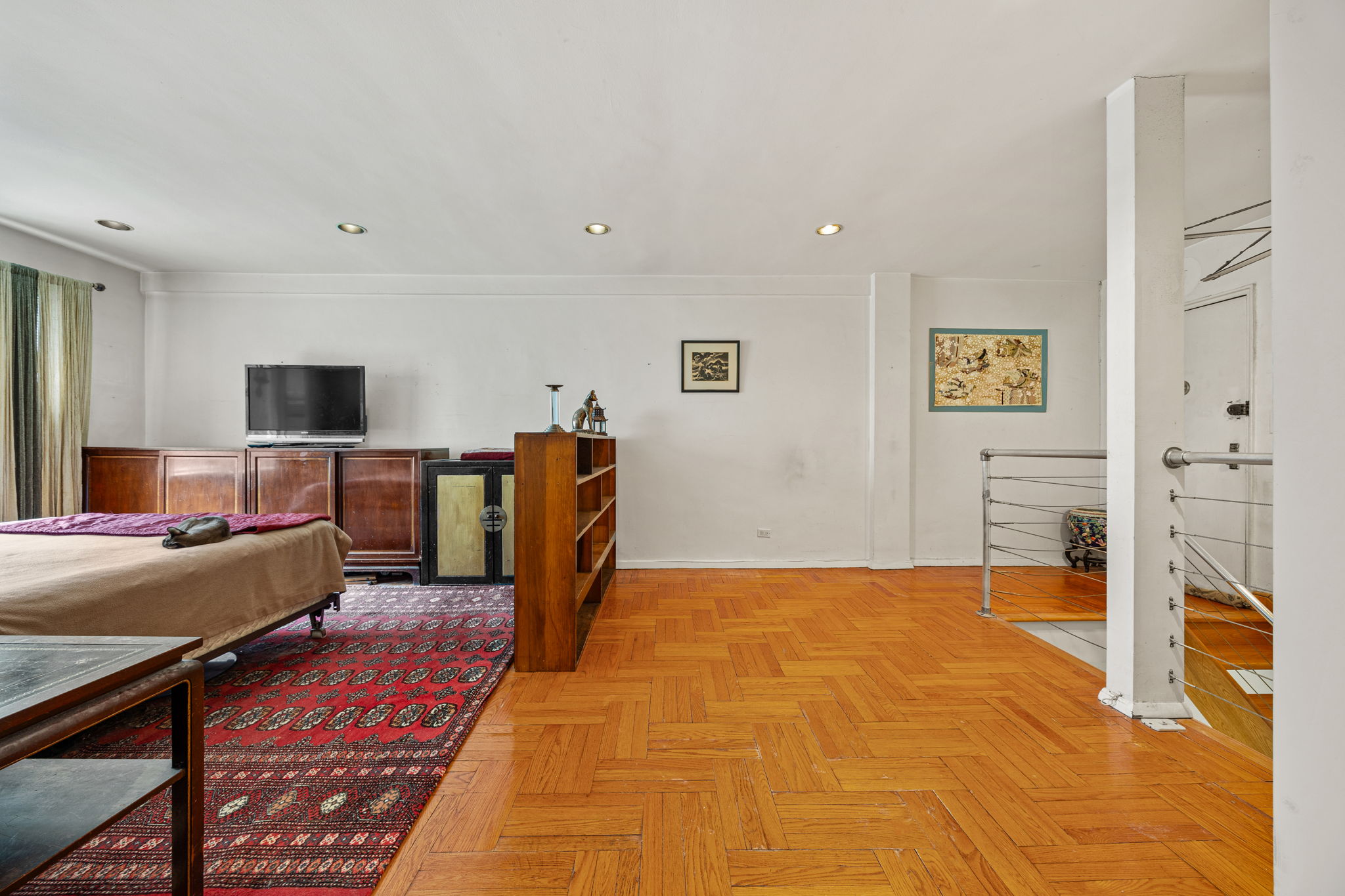 3850 Hudson Manor Terrace, Unit 1EE/2EE Bronx, NY 10463 - Photo 12 of 27 a bedroom with furniture and a flat screen tv