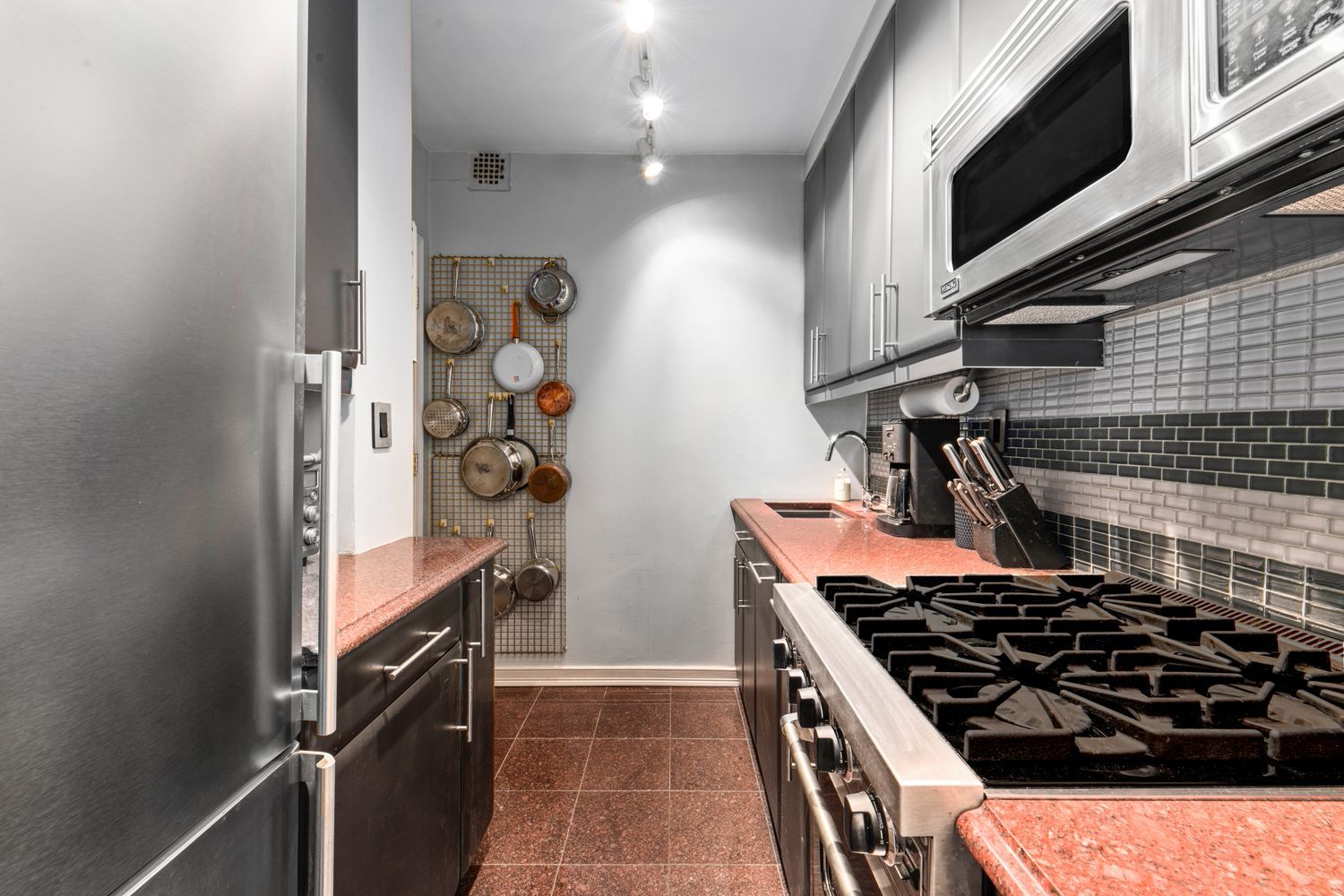 345 East 54th Street Manhattan, NY 10022 - Photo 8 of 10 a kitchen with a stove and a microwave
